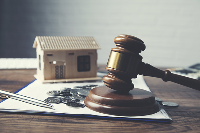 Image shows a pen, coins, a house, and a gavel.