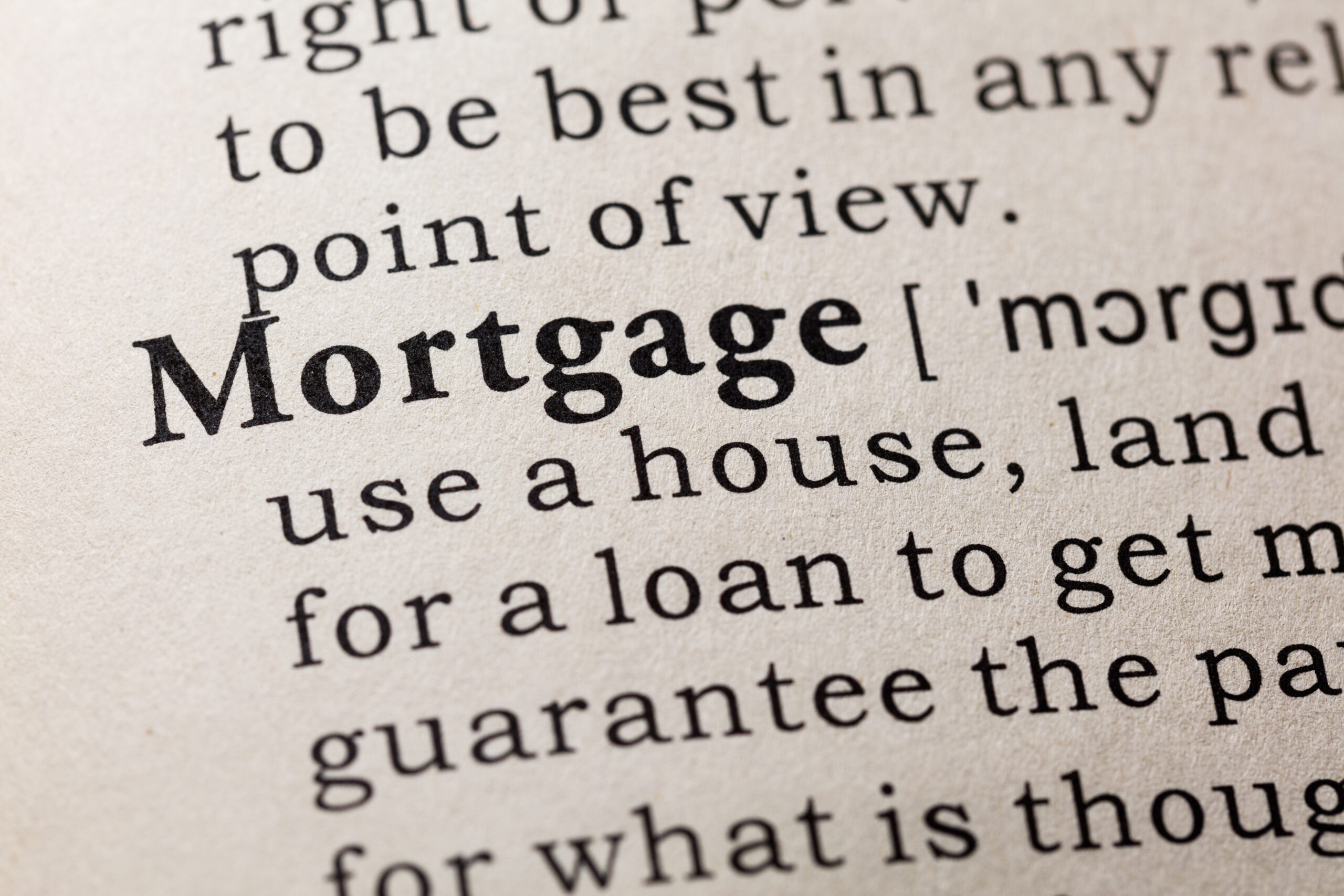 Black text appears on a white background. The image shows just a clip, but it seems it is a page from dictionary. The word "mortgage" appears in bold, with additional text that is not shown in whole.