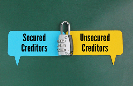 blog The words "Secured Creditors" and "Unsecured Creditors" appear in blue and yellow speech bubbles respectively. Between them there is a combination lock.